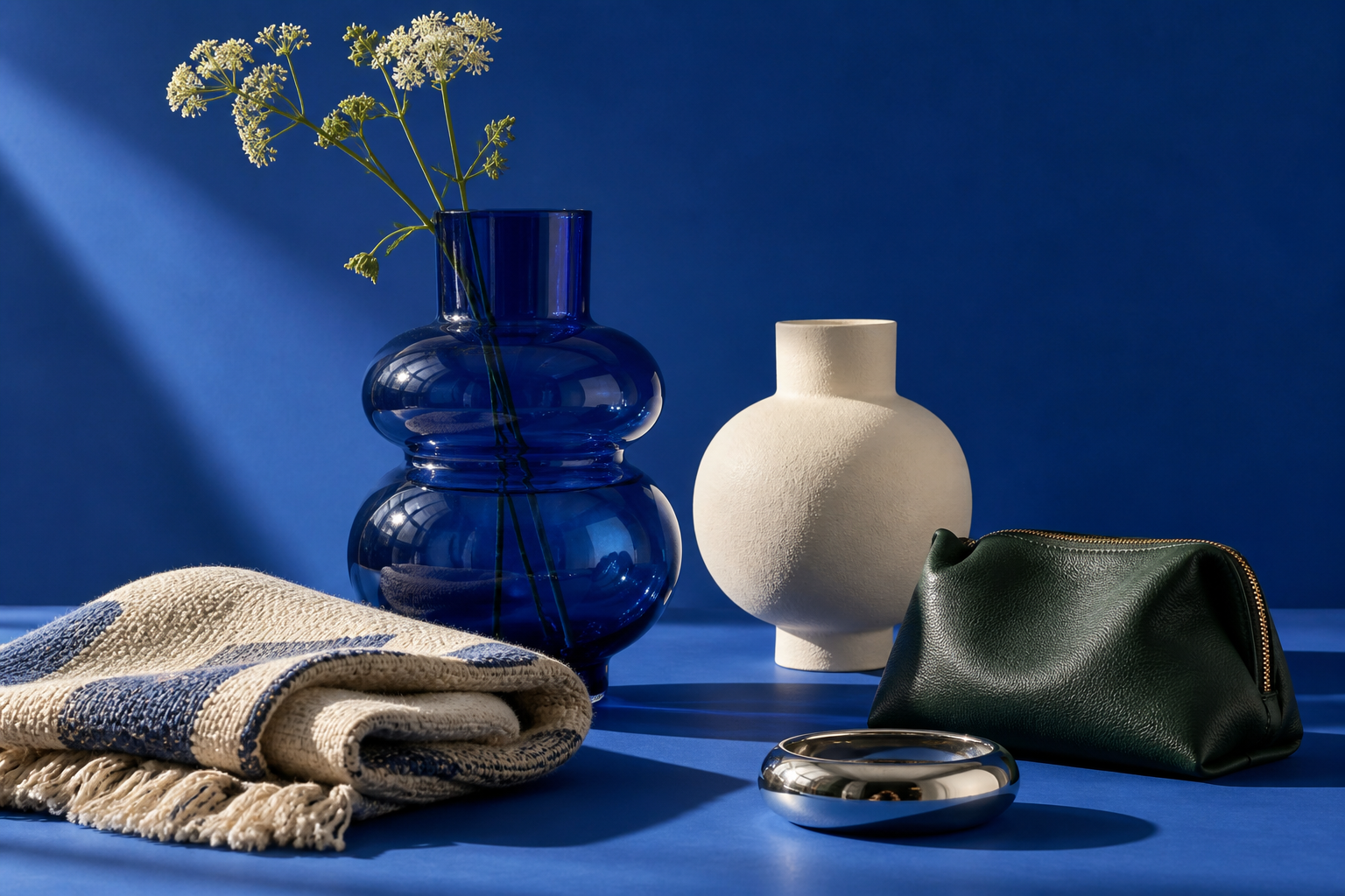 A blue still life with vases and everyday accessories